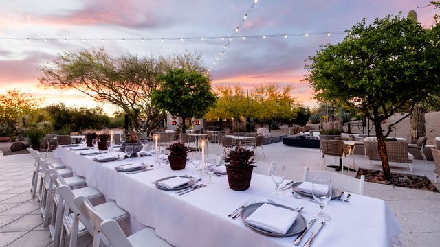 Dinner table set in the courtyard at sunset