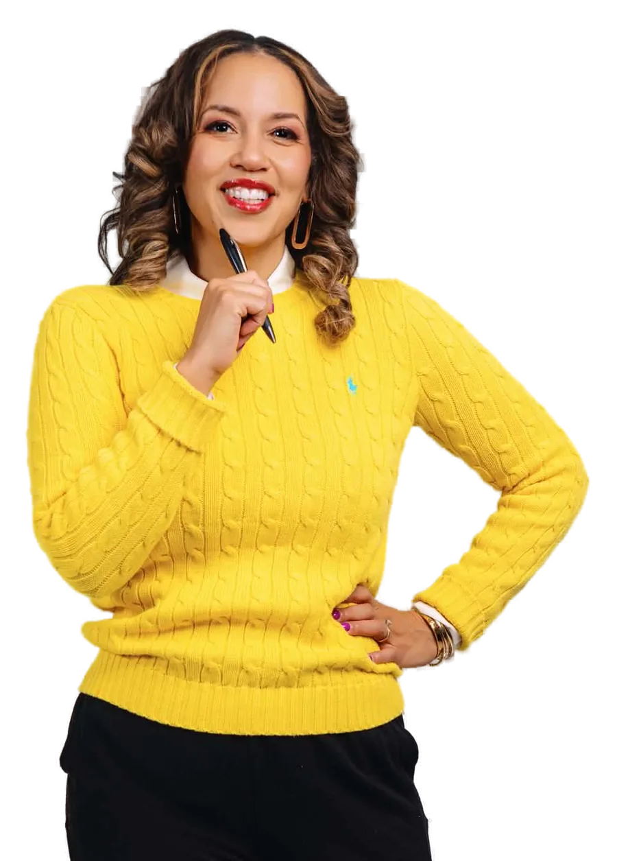 Dr. Alicia Watkins in a yellow sweater, smiling and holding a pen